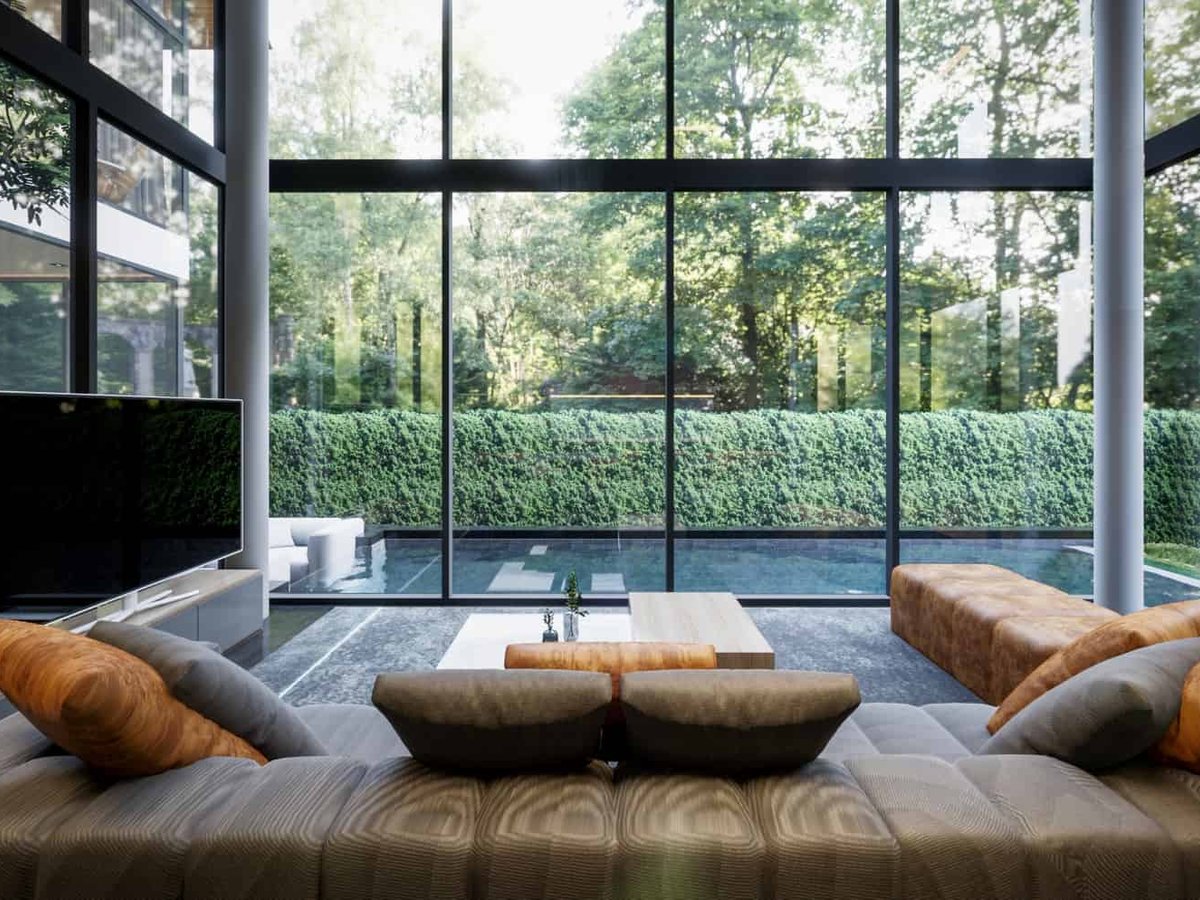 Rainpalm Villas — double-height living room with a pool view